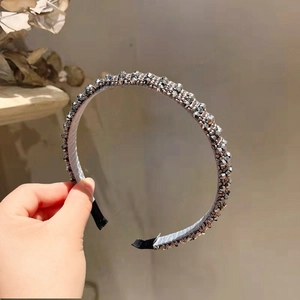 Detail of dark gray crystal beaded headband with multi-faceted metallic beads