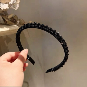 Detailed view of handmade black beaded crystal headband with soft inner velvet lining