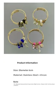 Detail of adjustable stainless steel bracelets with charms and zircon butterfly knots