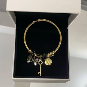 Detail of golden stainless steel bracelet with tree of life pendant and crystal beads