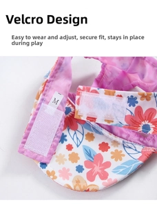 Detail view of floral pet baseball cap showing adjustable velcro closure and M size tag