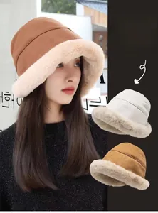 Close-up detail of plush suede winter bucket hat with faux fur trim in brown and beige