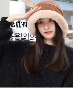Close-up of thick winter bucket hat with brown fabric and plush faux fur brim