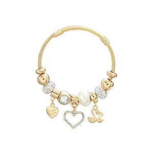 Detail of golden cable bracelet with swan charms, pearl beads and heart tag