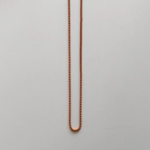 Detailed view of the vibrant orange resin bear pendant necklace box chain structure