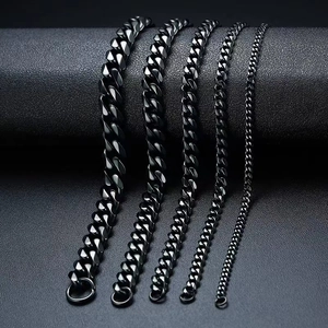 Set of five black stainless steel Cuban link bracelets in various widths on display