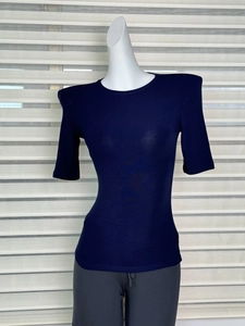 Close-up of slim-fit navy blue T-shirt featuring structured shoulder pads and round neck