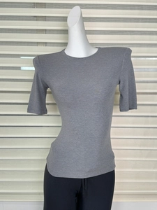 Detail of grey slim fit T-shirt featuring structured shoulder pads and round neckline