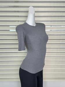 Detail of grey slim-fit ribbed knit top with a classic crew neck and five-point sleeves