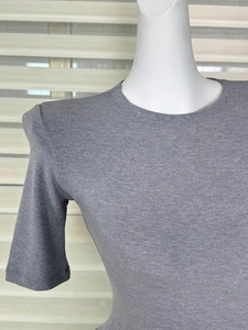 Close-up of the round neckline and ribbed knit texture on a grey slim fit t-shirt
