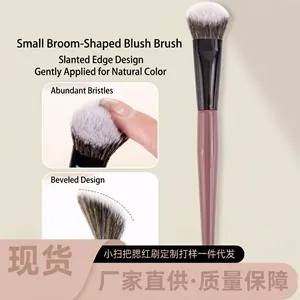 Detailed view of the angled blush brush with pink handle and dense gradient bristles