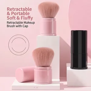 Close-up of portable retractable makeup brush with soft bristles in pink and black