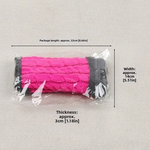 Detail view of pink cable knit leg warmers in packaging with measurements 22x14x3cm