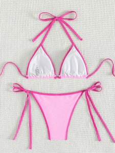 Detailed flat lay of pink color-block bikini set with neck tie and side-tie high waist bottoms