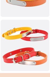 Detail view of adjustable leather pet collars in yellow and red with blank metal ID tags