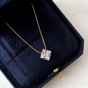 Elegant gold 6-prong square cut zircon pendant necklace on blue velvet display