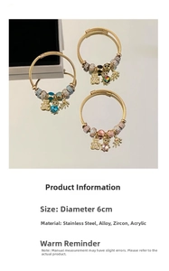 Detail of adjustable golden bracelet with bear heart charms and colorful zircon stones
