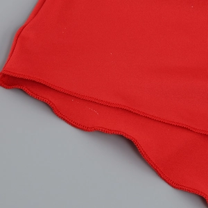 Close-up of the red ruffled hem with meticulous stitching and ribbed fabric texture