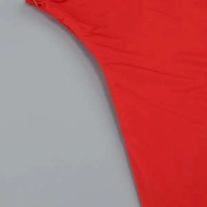 Detailed close-up of red ruffled hemline with professional stitching on summer dress