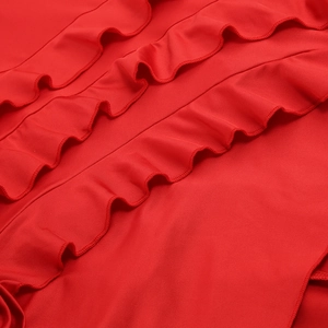 Detailed close-up of layered red ruffle design on a stylish summer vacation dress