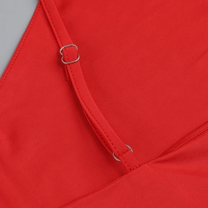 Detail of red dress with adjustable spaghetti strap and silver metal slider hardware