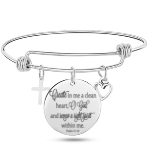 Macro shot of polished stainless steel bangle with engraved Psalm 51:10 pendant and cross