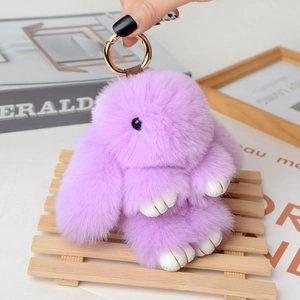 Detailed view of purple plush bunny charm with soft fur and golden spring clip