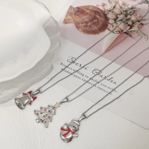 Stainless steel Christmas necklace set featuring bell, tree and snowman pendants