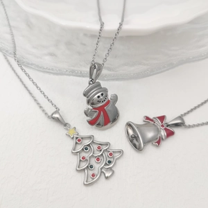 Detail of Christmas snowman, tree and bell pendants with colorful enamel on metal chains