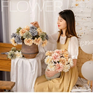 Close-up of multi-colored faux dahlia flowers in vintage ceramic vases for home decor