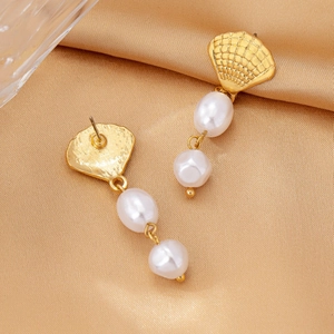 Elegant gold scallop shell earrings with hanging double white pearls on silk background