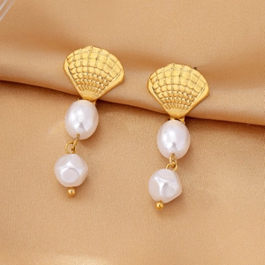 Elegant gold shell earrings with pearl fringe pendants on golden satin fabric backdrop