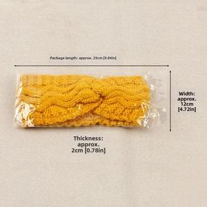 Close-up of yellow knitted winter headband showing dimensions of 25cm in original packaging