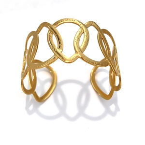 Gold-plated stainless steel open cuff bracelet featuring an interlocking ring design