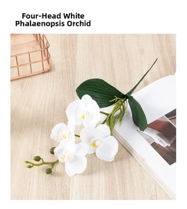 Close-up of white 4-head artificial phalaenopsis orchid with realistic textured green leaves