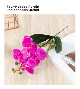 Detail of purple artificial orchid with four flower heads and green buds on a wooden table