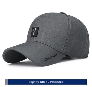 Detail of gray cotton baseball cap featuring black exclusive patch and side embroidery
