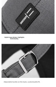 Detail of grey baseball cap showing twill fabric logo and adjustable metal buckle