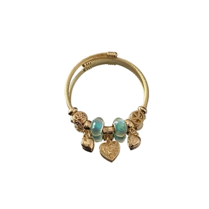 Adjustable golden twisted bangle with heart charms and light blue faceted crystal beads