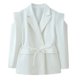 Detail of white blazer featuring padded shoulders, lapel collar, and matching waist belt