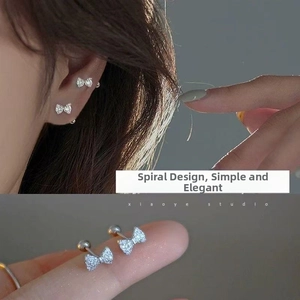 Detailed macro view of 925 sterling silver bow earrings with sparkling cubic zirconia stones
