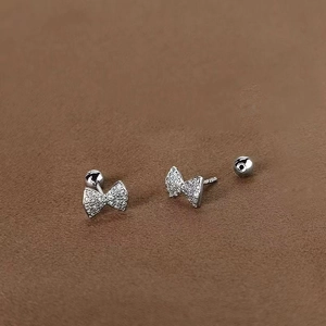 Detail of 925 sterling silver bow earrings with sparkling zircon and screw ball backs