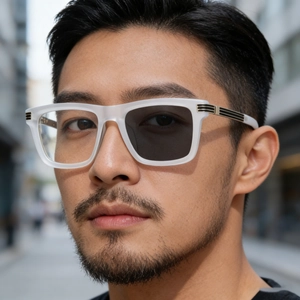 Detail of photochromic lenses changing color on square frosted frame with metal accents