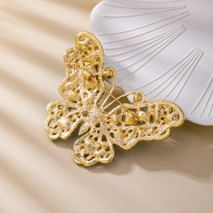 Elegant gold butterfly brooch with intricate mesh wings and secure pin clasp closure