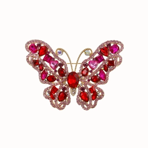 Detailed close-up of a vintage 3D butterfly brooch with red crystal rhinestones