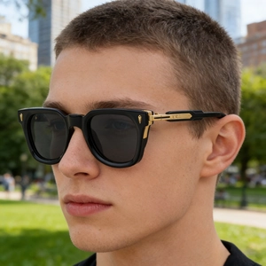 Close-up of square polarized sunglasses with gold metal details on a male model