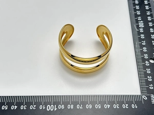 Top view of gold double-layer open bangle with ruler showing its 60mm diameter and size