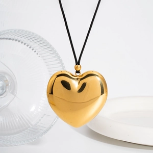 Polished hollow heart pendant necklace in 18k gold finish with black cord strap