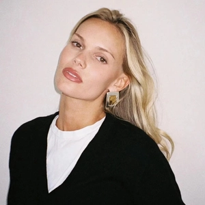 Detailed view of model wearing minimalist square two-tone stainless steel stud earrings