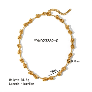 Macro view of gold stainless steel wavy chain necklace with lobster clasp and extension